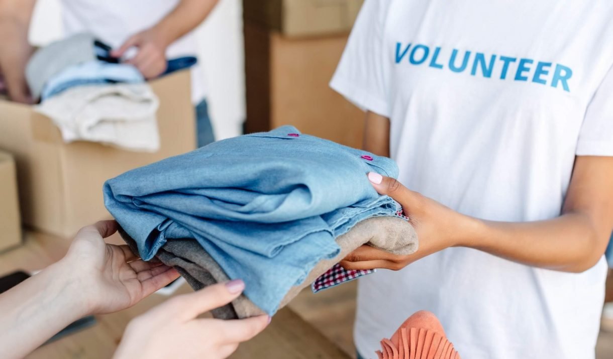 Cropped View Of Volunteer Giving Clothes To Woman 2022 12 16 21 31 45 Utc Scaled 1 1220x715