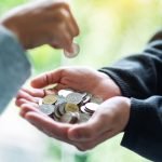 Closeup Image Of A Hand Putting Coins Into Another ZF32UUR Scaled 1 150x150